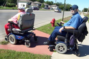People in motorized wheelchairs