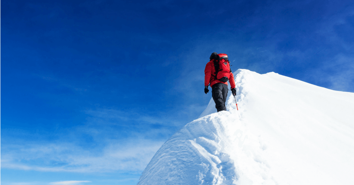 man-climbing-snowy-mountain