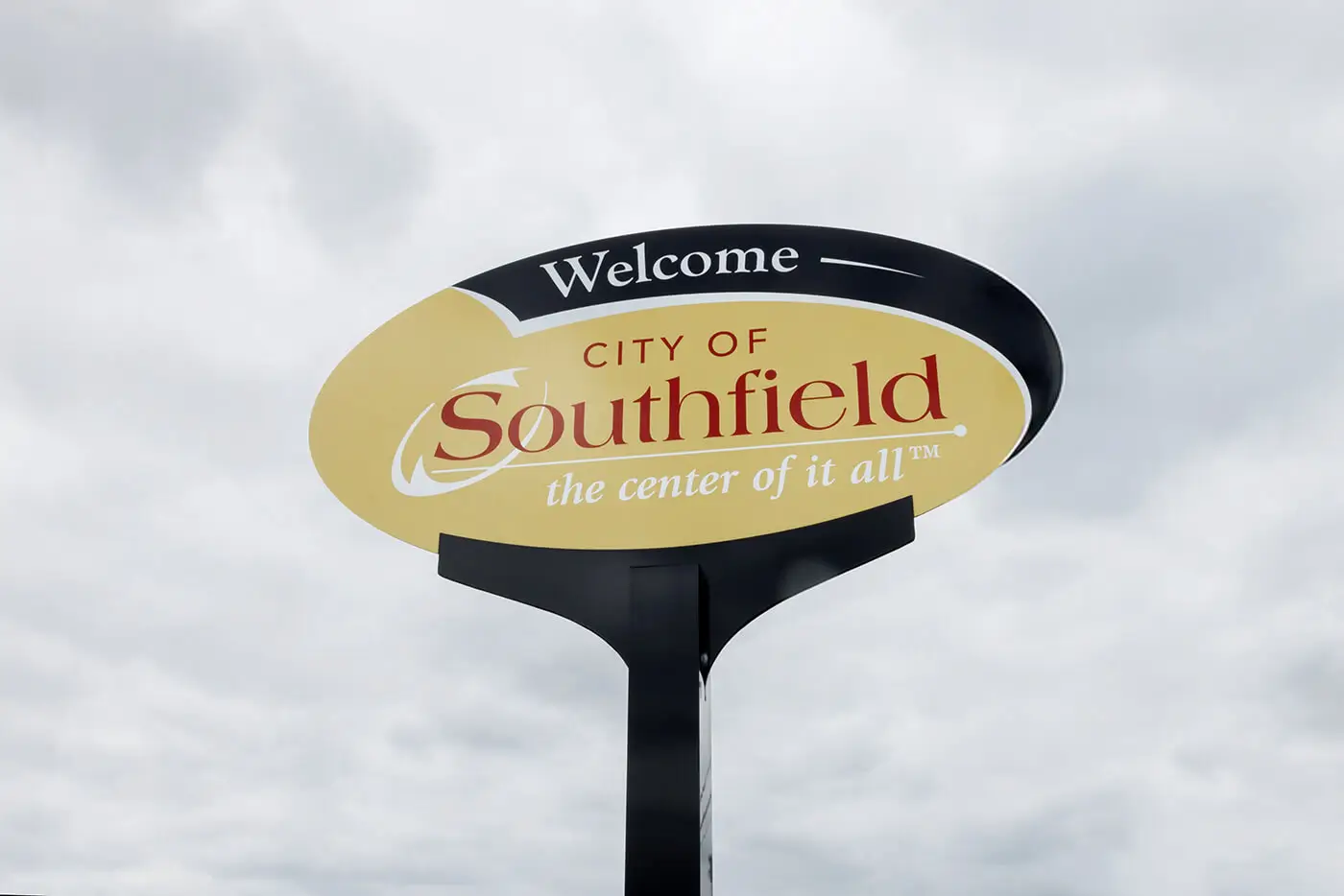 Passing cars near the City of Southfield welcome sign help illustrate the community served by a car accident lawyer in Southfield.