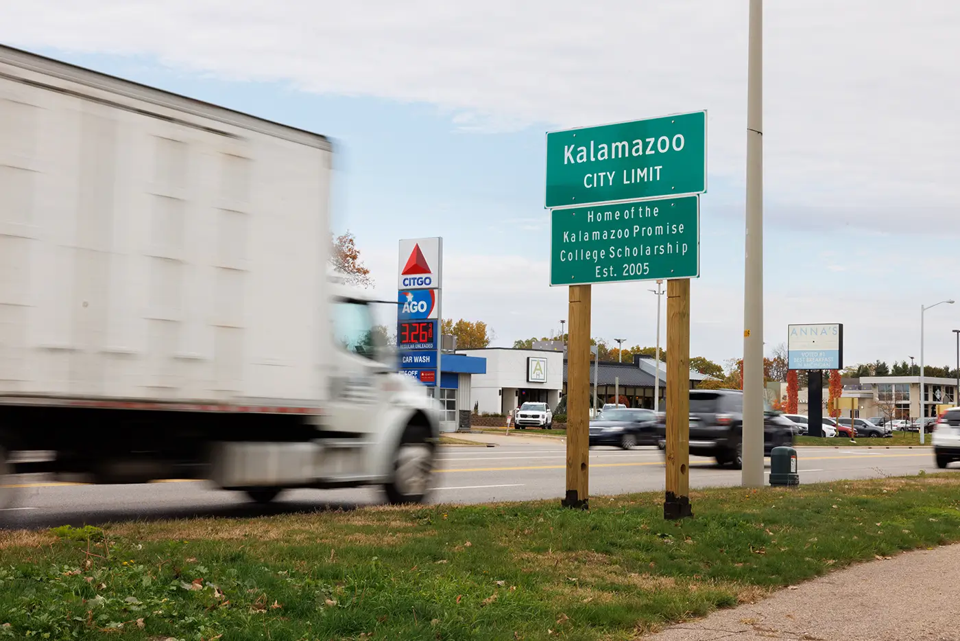 Truck driving past the Kalamazoo city limit sign near roads where Michigan Auto Law handles truck crash cases in Kalamazoo.