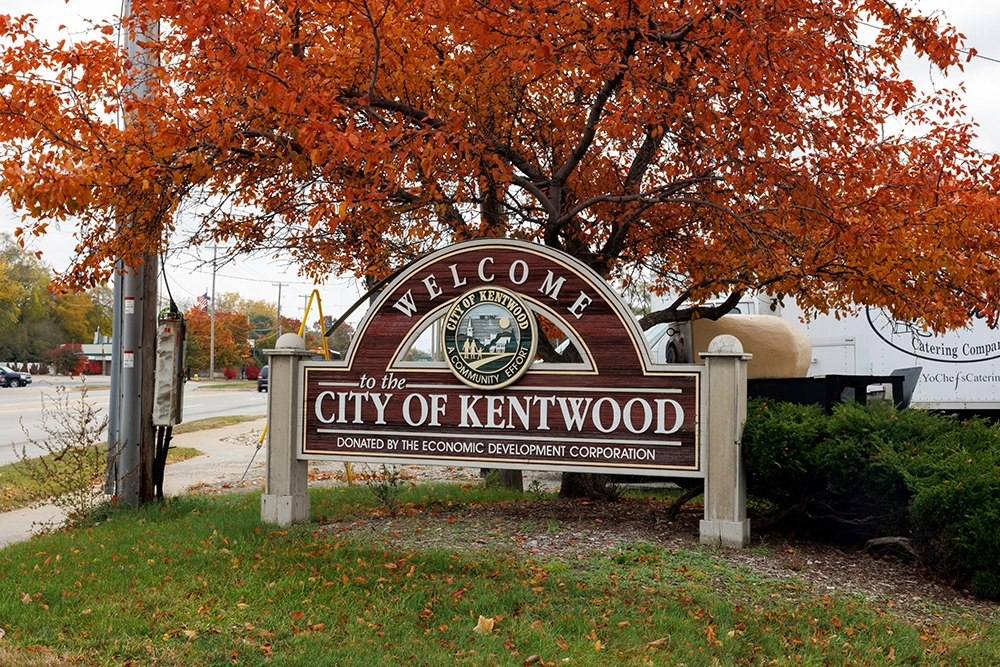 Fall foliage near City of Kentwood welcome sign, showing the local area where Kentwood truck accident lawyer, Michigan Auto Law, may handle claims.