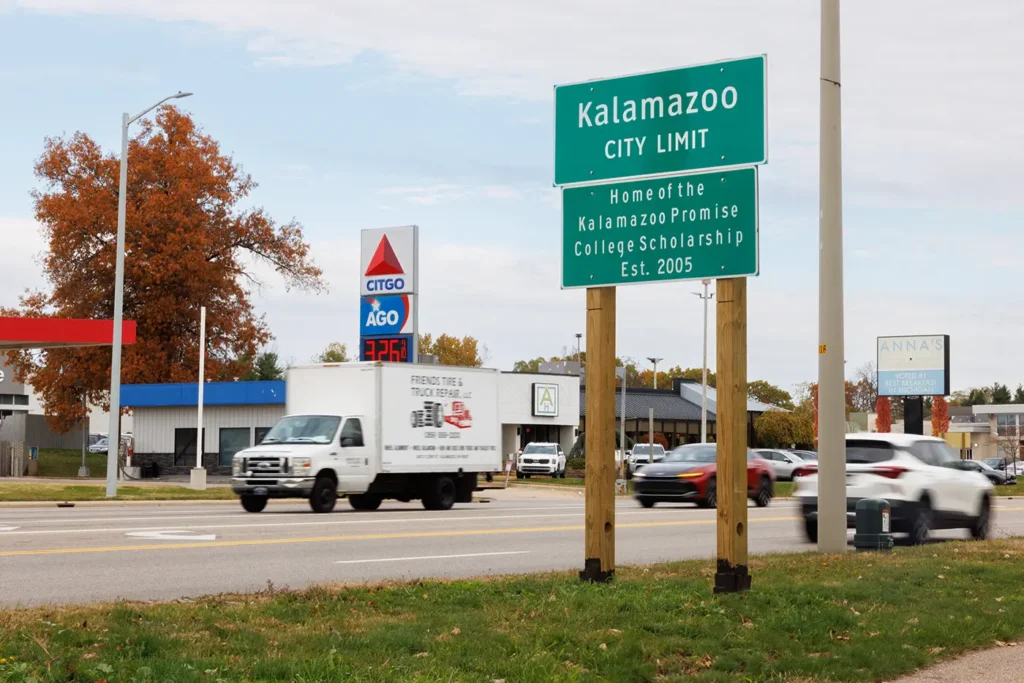 A passing box truck near the Kalamazoo city limit sign shows the kind of local traffic scene where a truck accident law firm in Kalamazoo may help.