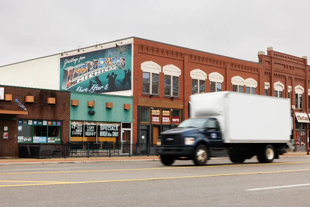 Building with “Greetings from Lansing” mural, representing the community where Michigan Auto Law offers truck accident law in Lansing.