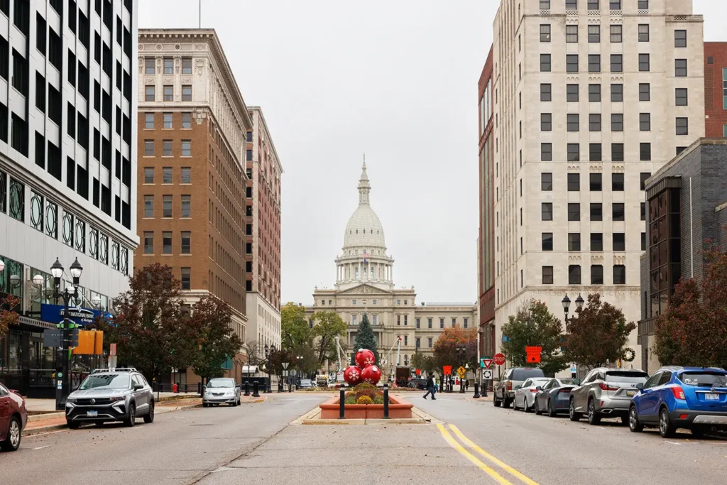 Lansing street leading toward the Michigan State Capitol, showing a local roadway where a truck accident lawyer in Lansing may handle crash cases.