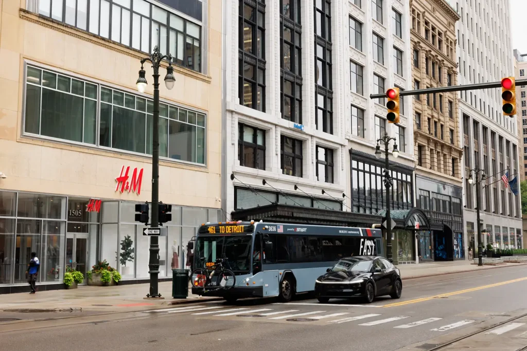 Bus on a downtown Detroit roadway, where Michigan Auto Law helps victims as a bus accident lawyer in Detroit.
