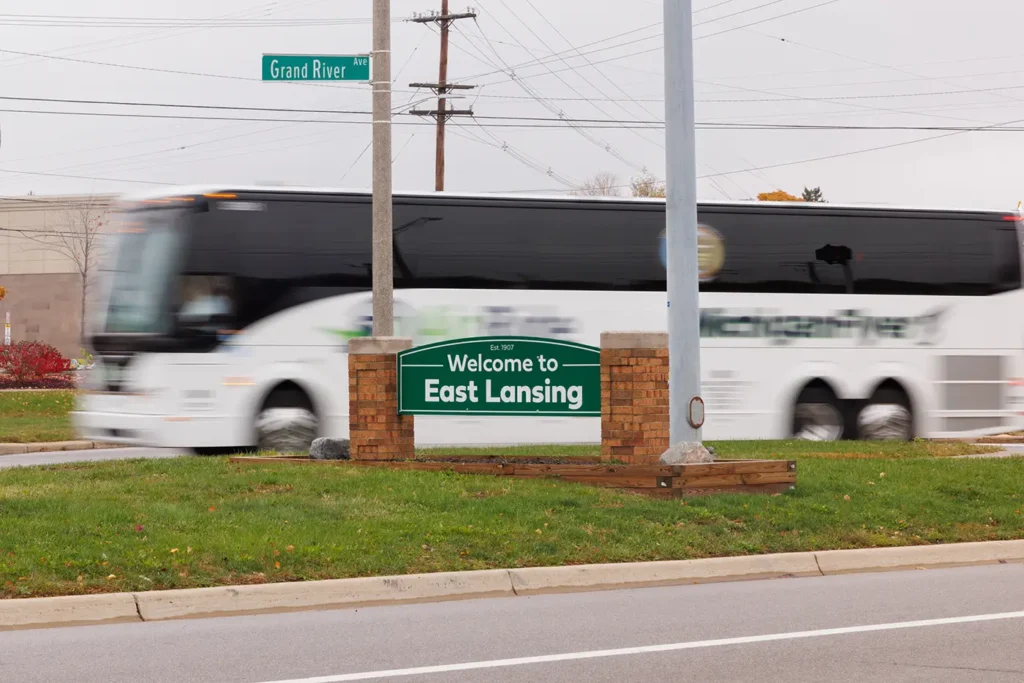  A bus travels through East Lansing near Grand River Avenue, representing an area served by Michigan Auto Law as a bus accident lawyer in East Lansing.