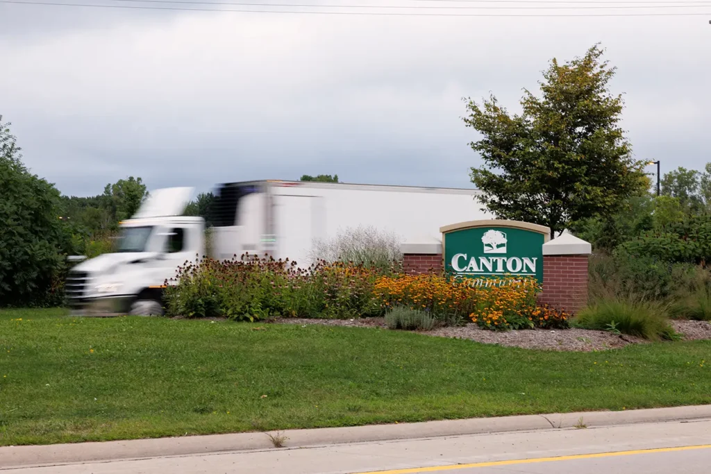 Truck passes the Canton community sign, where Michigan Auto Law serves as a truck accident lawyer in Canton.