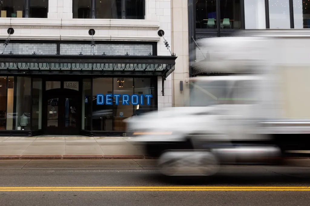 Downtown Detroit roadway with a passing delivery truck, representing the area served by Michigan Auto Law as a Detroit truck accident attorney.