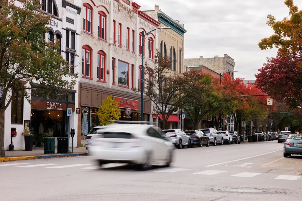 Downtown street with passing traffic, highlighting Michigan Auto Law as a Lyft accident attorney in Traverse City.