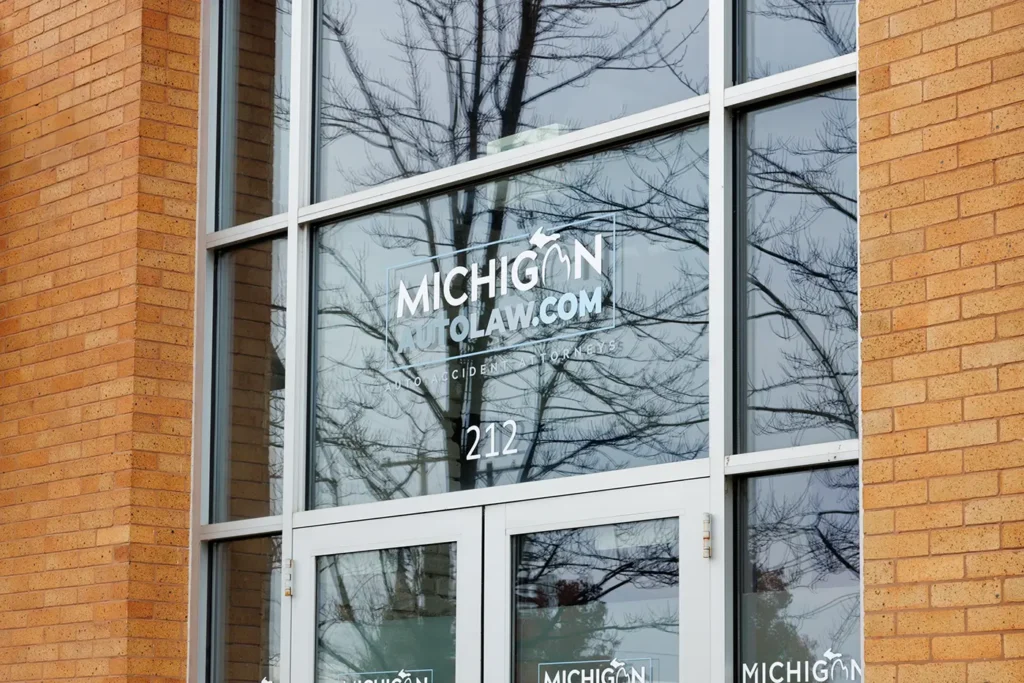 Glass doors and signage at the Michigan Auto Law office, a motorcycle crash law firm in Grand Rapids.
