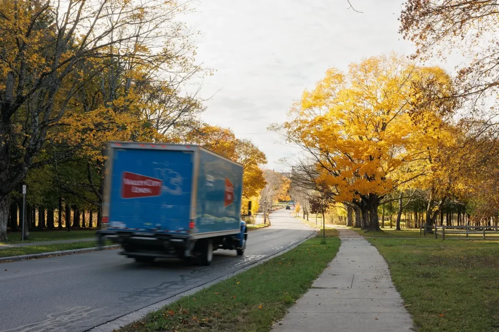 Moving truck drives through Traverse City roads, representing Michigan Auto Law as a truck accident attorney in Traverse City.