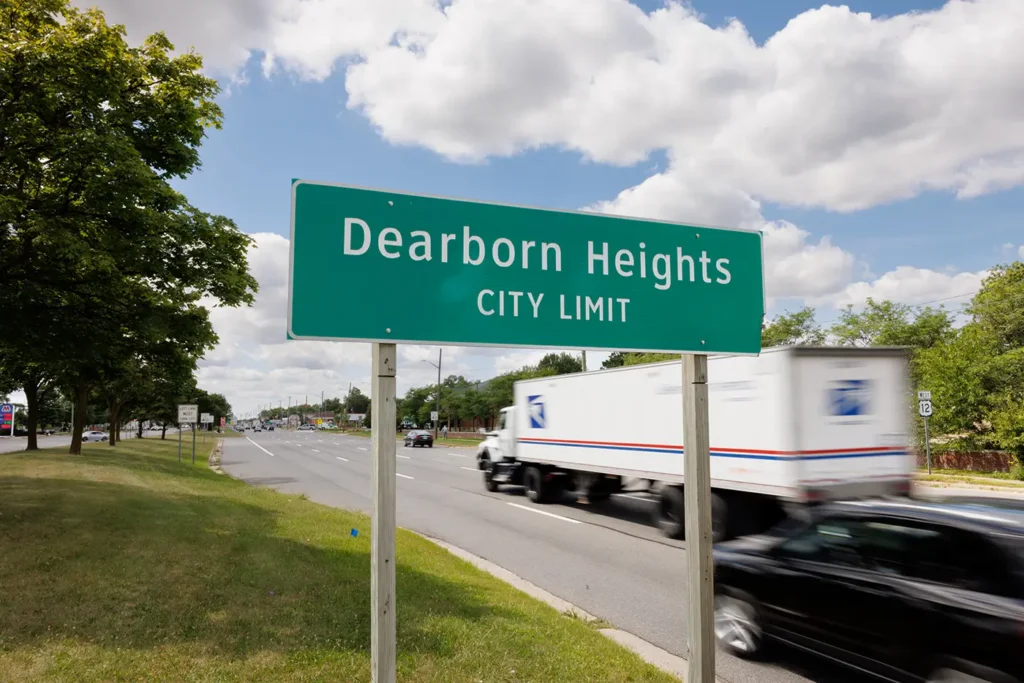  Truck traffic by the Dearborn Heights city limit sign, where Michigan Auto Law helps victims as a truck accident lawyer in Dearborn Heights.
