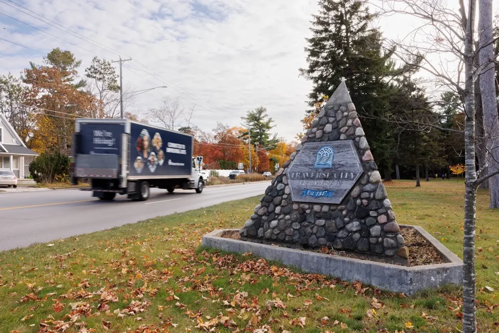 Truck drives past the Traverse City monument, highlighting Michigan Auto Law’s truck crash lawyer help in Traverse City.