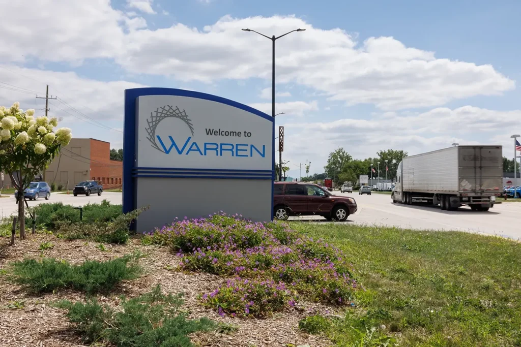Truck traveling past the Welcome to Warren sign, showing roads tied to Michigan Auto Law Warren truck accident cases.