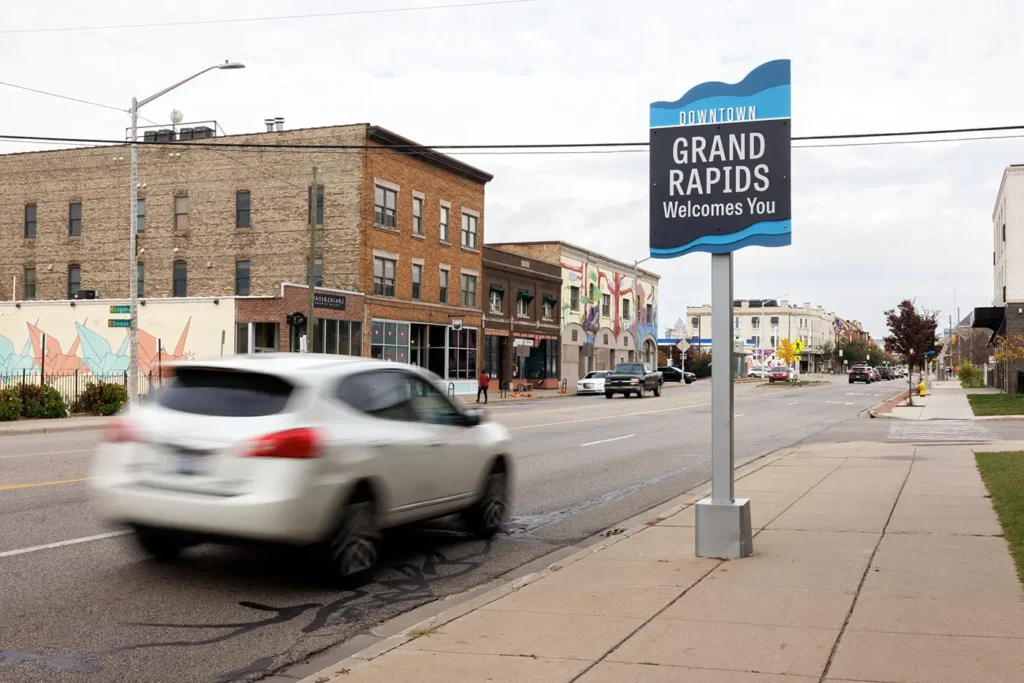 Moving cars and storefronts in downtown Grand Rapids, where Michigan Auto Law handles Uber accident cases.