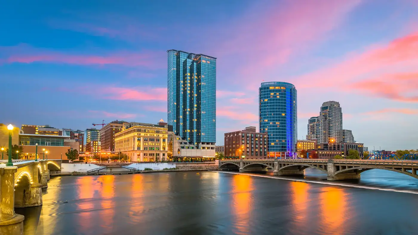 Riverfront skyline in Grand Rapids at dusk, highlighting Michigan Auto Law as an Uber crash lawyer in Grand Rapids.