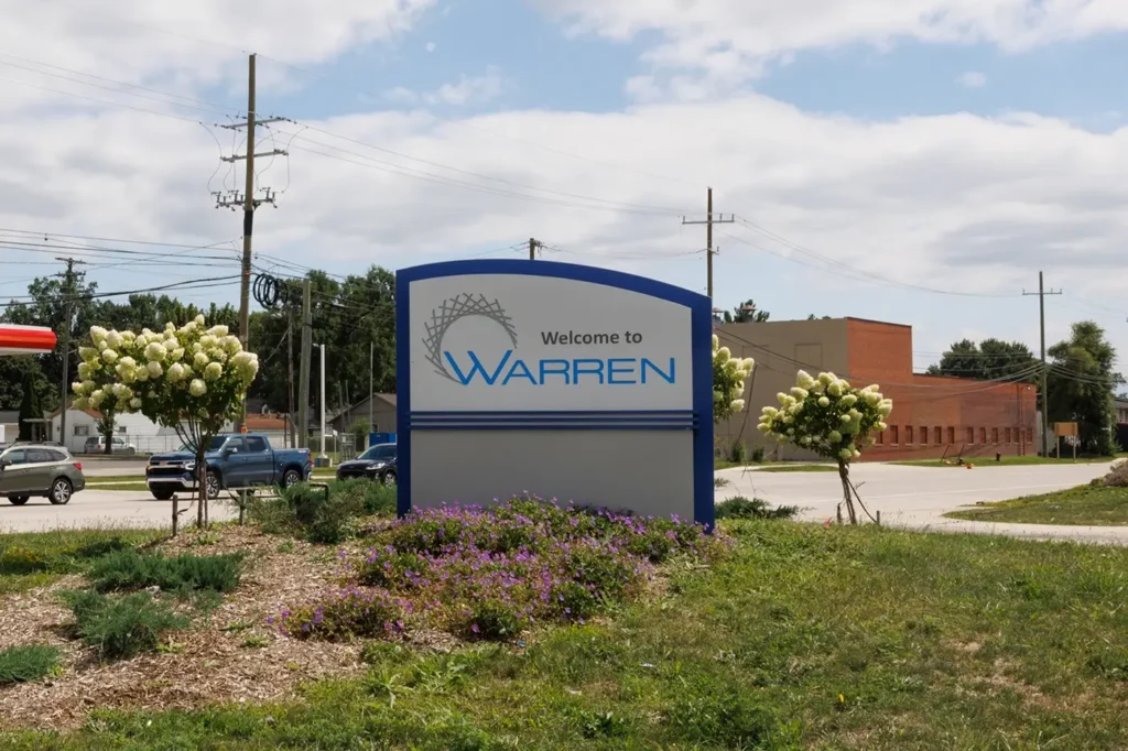 Welcome to Warren sign along a local roadway, representing the area Michigan Auto Law serves for car crash attorney cases.