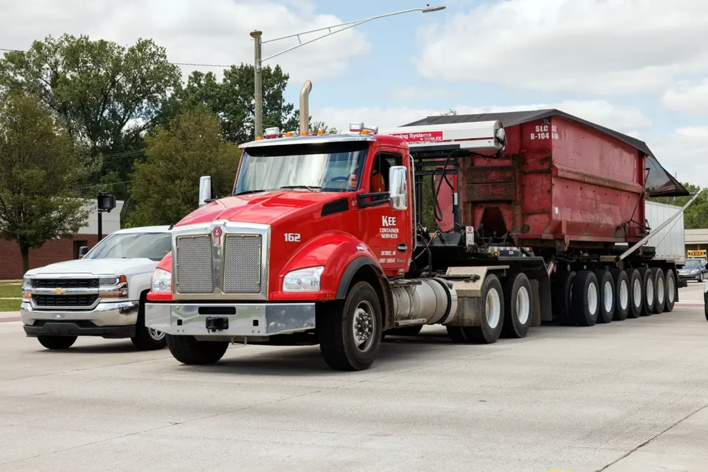 Red semi truck in Warren traffic, highlighting Michigan Auto Law as a Warren truck accident lawyer.