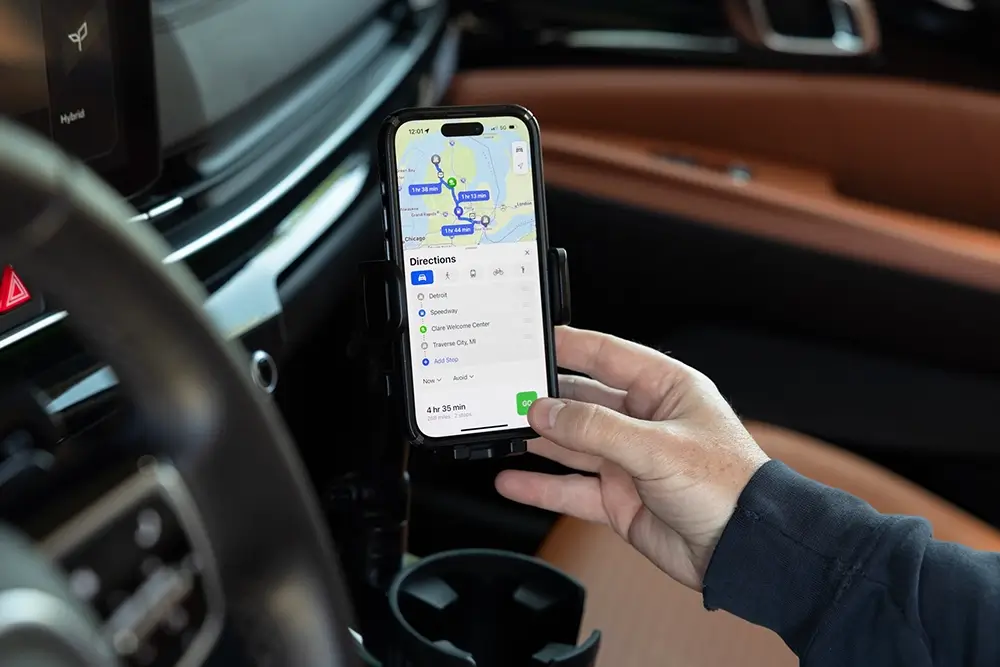 Driver reviewing navigation in the car as part of what to do before a road trip.