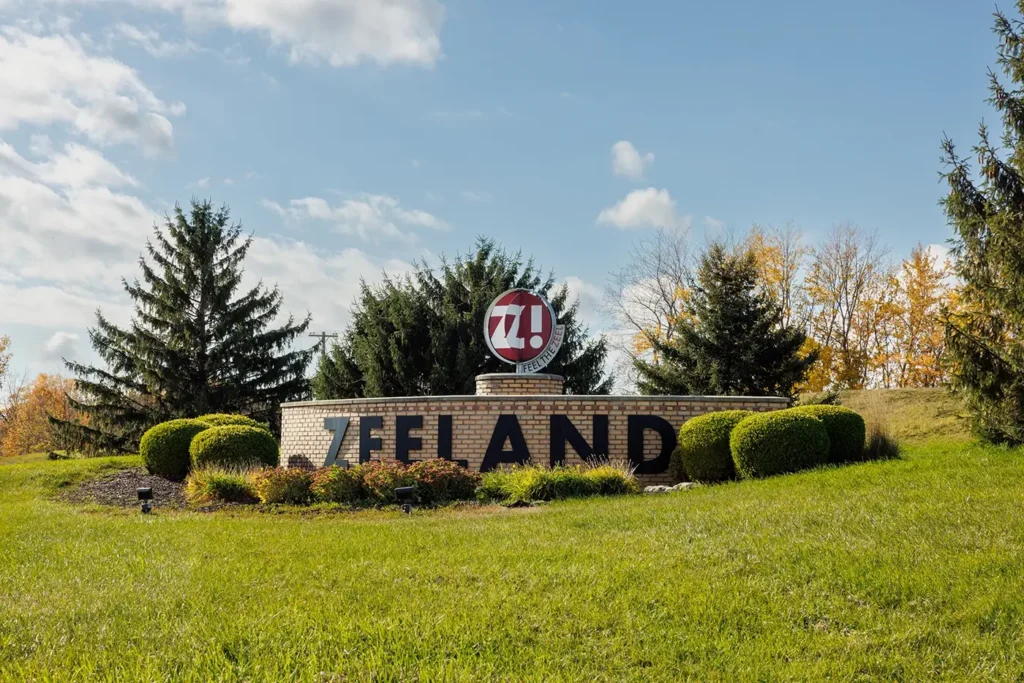 Neighborhood welcome sign in Zeeland, used to depict the local community served by Michigan Auto Law as a car accident lawyer.