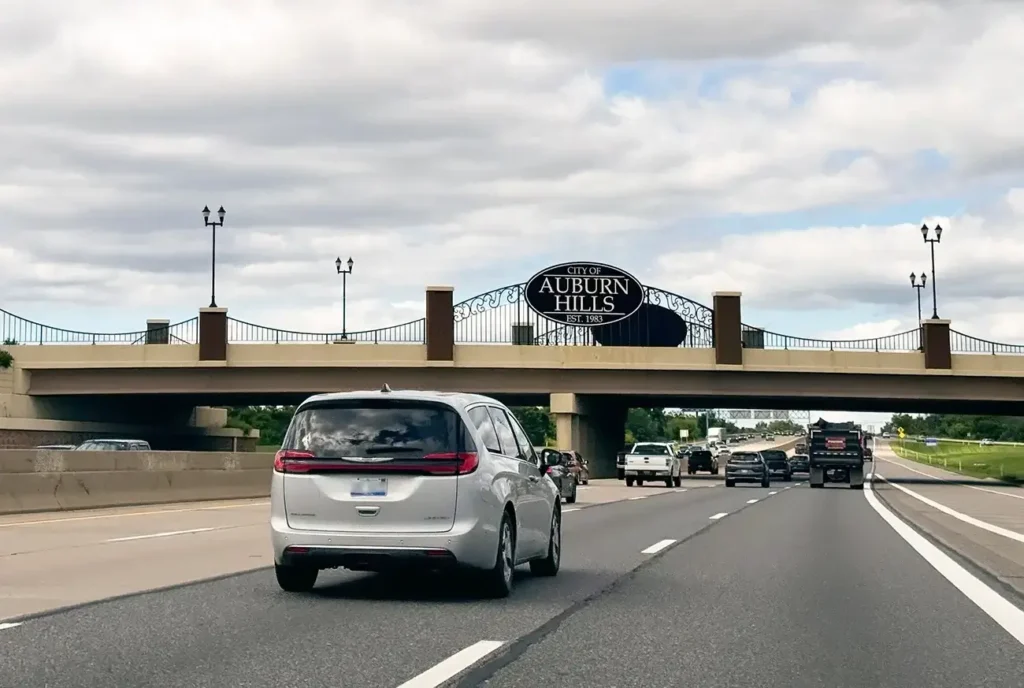 Traffic traveling beneath an overpass, highlighting roadways similar to those Michigan Auto Law's Auburn Hills car accident lawyers handle.
