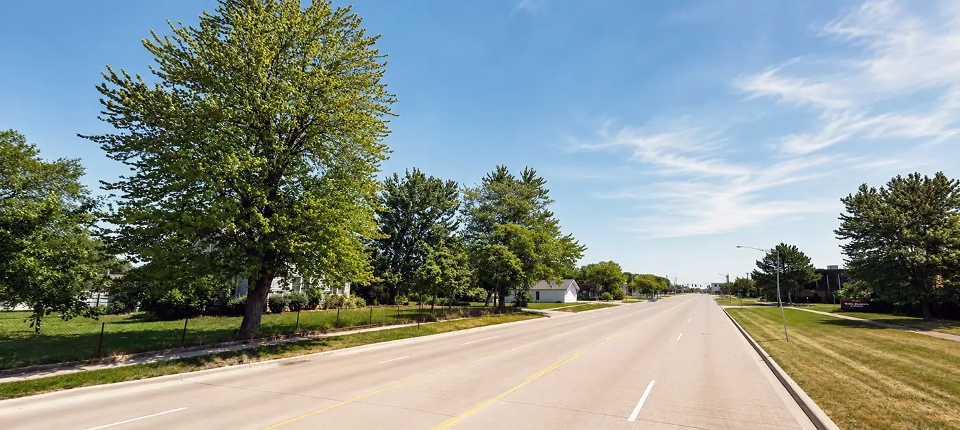 Tree-lined roadway highlighting Michigan Auto Law car crash lawyer services in Berkley.