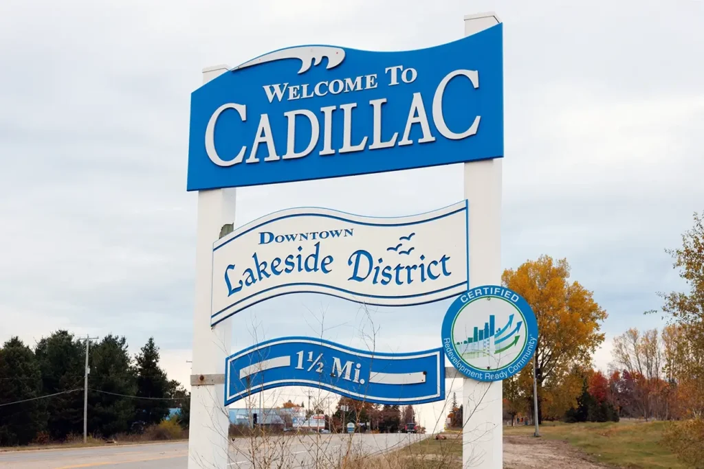 Welcome to Cadillac Downtown Lakeside District sign, highlighting Michigan Auto Law's Cadillac car accident law firm.