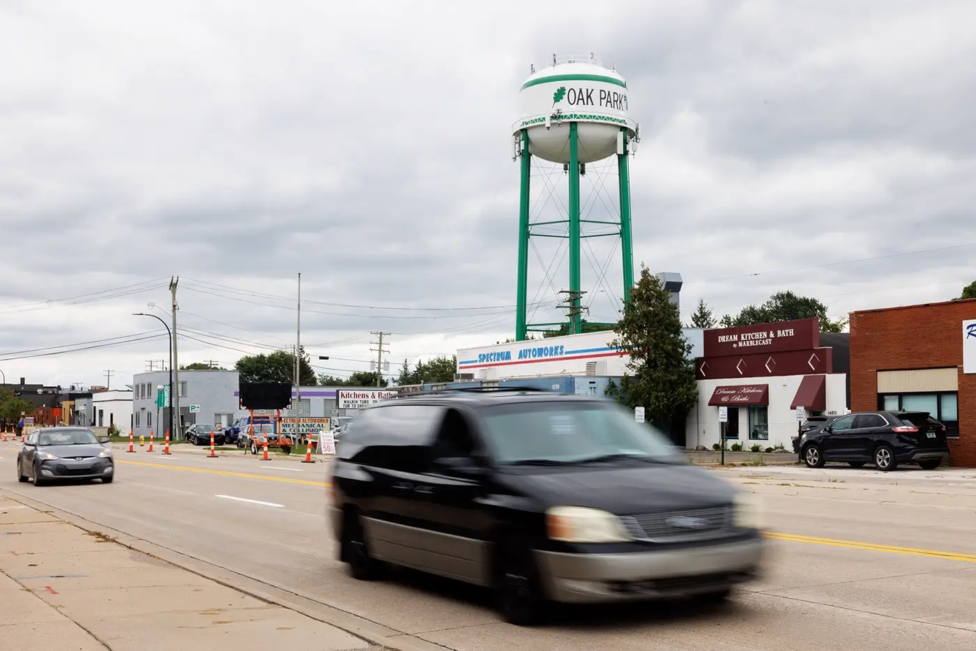 Traffic passes the Oak Park water tower, where Michigan Auto Law is a car accident attorney.