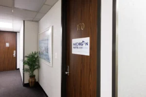 Office hallway with Michigan Auto Law signage, a car accident attorney in Sterling Heights.