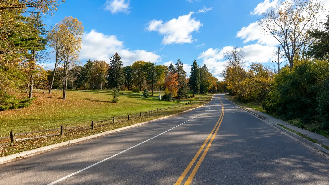 Scenic road through a Farmington Hills park representing where Michigan Auto Law provides car accident lawyer services.