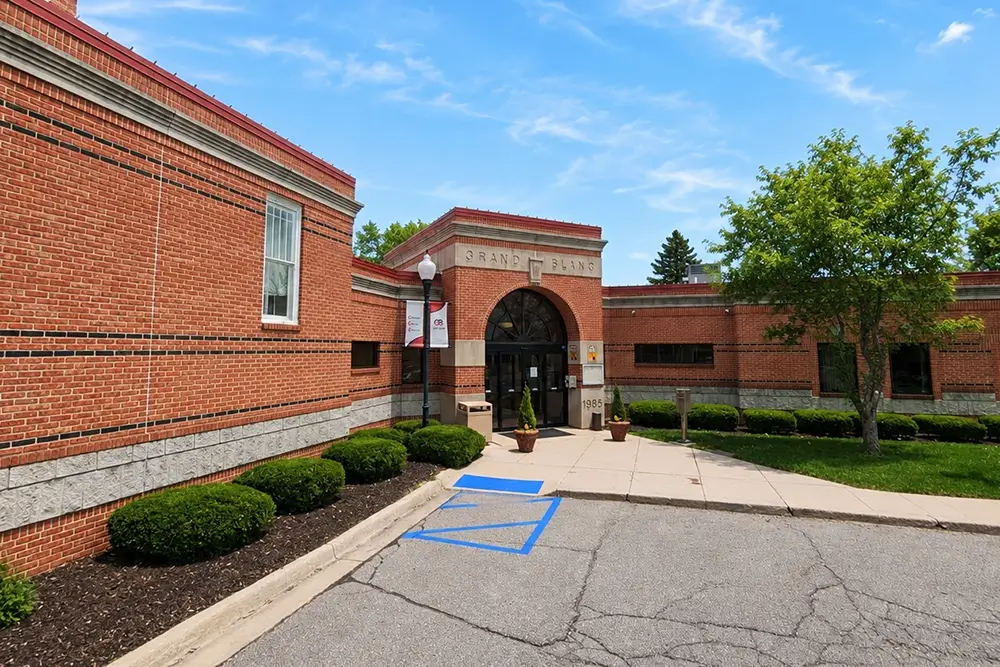 Grand Blanc brick building entrance, highlighting Michigan Auto Law car crash lawyer services.