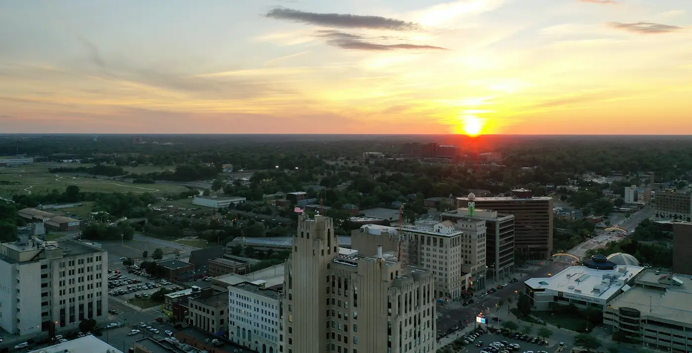 Flint skyline at sunset representing Michigan Auto Law support after Lyft accidents.