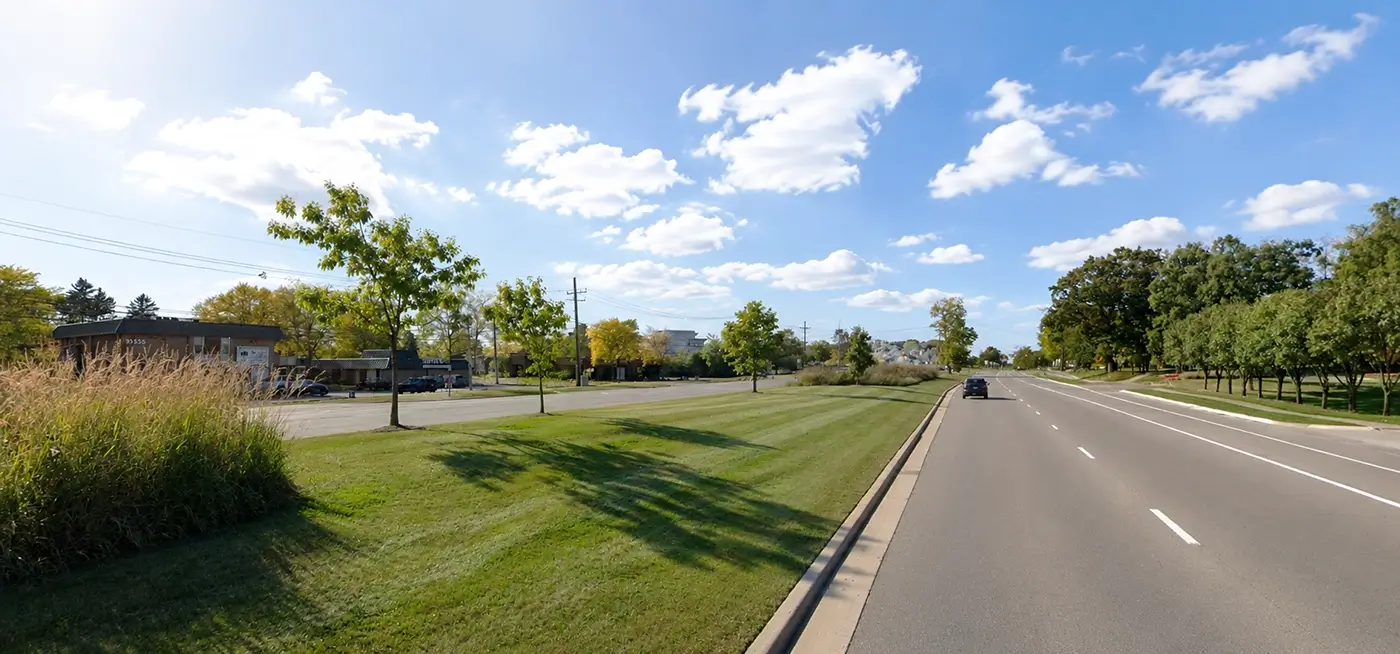 Broad Farmington Hills street with landscaped median, representing truck accident lawyer Farmington Hills legal representation.