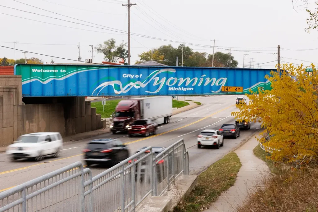 Semi-truck traveling beneath the City of Wyoming overpass, highlighting traffic conditions similar to those Michigan Auto Law's truck accident lawyers handle.